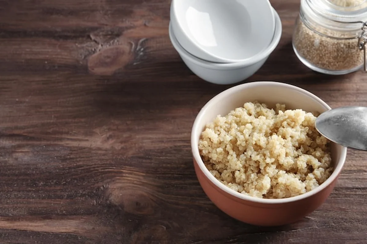 Miska z gotowaną kaszą jaglaną na drewnianym stole