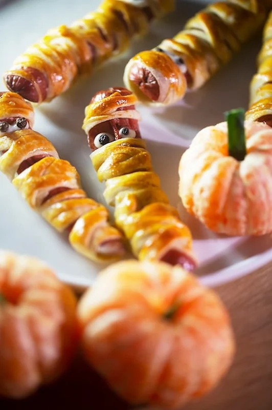 Przekąski na Halloween: mumie z ciasta i kiełbasy, oraz mandarynki